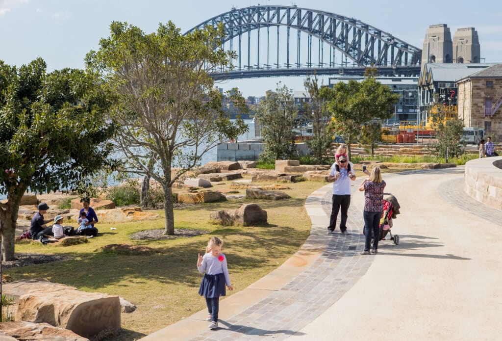 Terraced native landscape at Barangaroo Reserve with Sydney Harbour Bridge in background