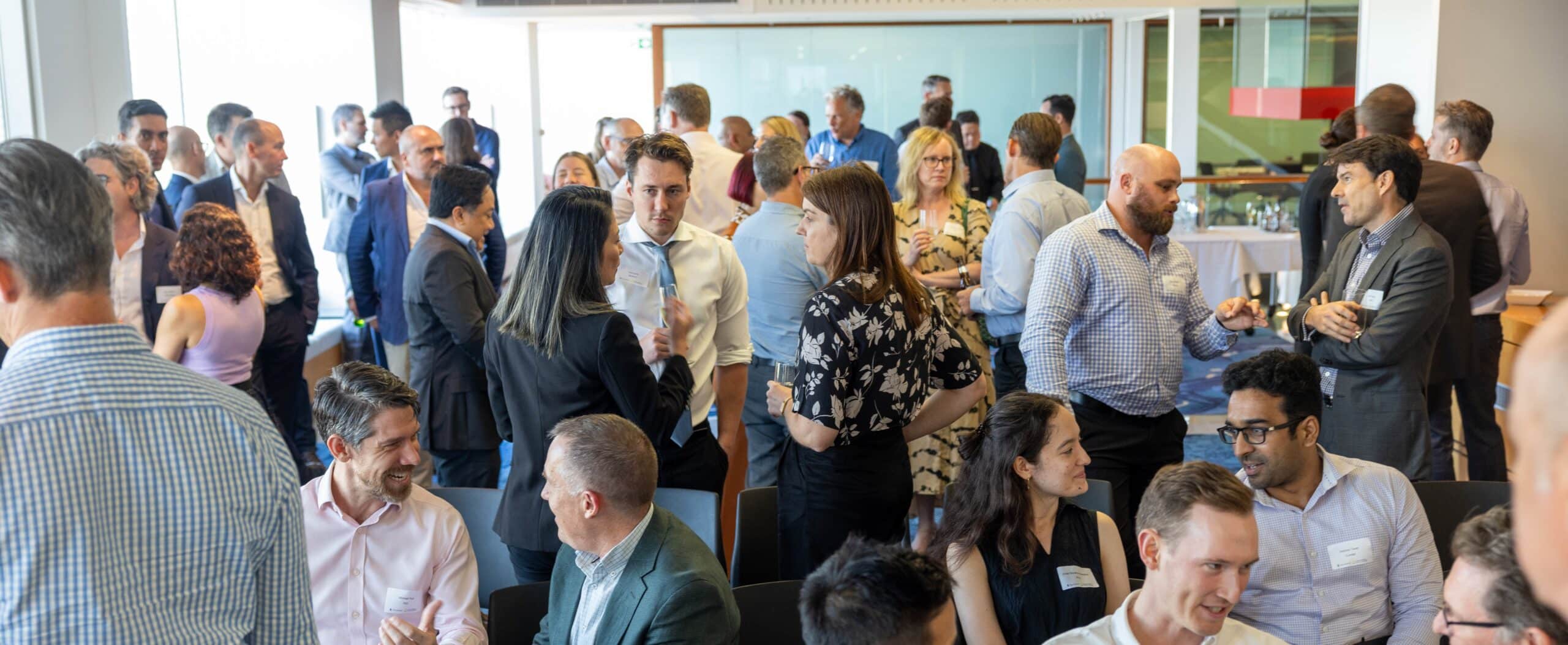 A group of business women and men networking in an office