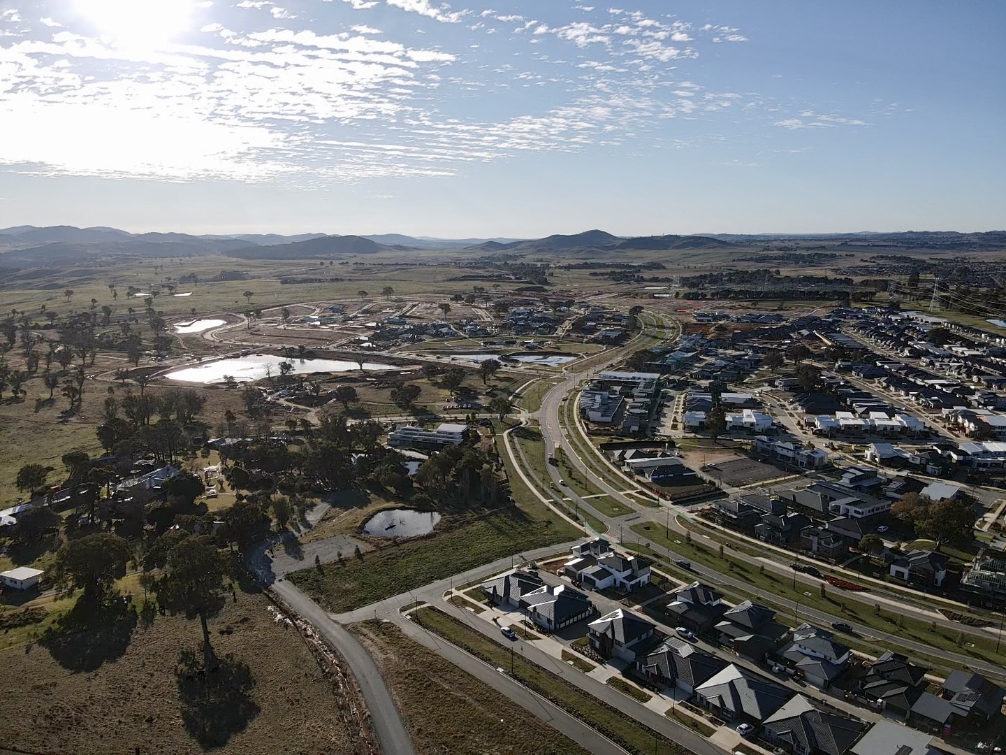 Aerial view of Ginninderry masterplanned community with new residential neighbourhoods, green infrastructure, and sustainable urban development.