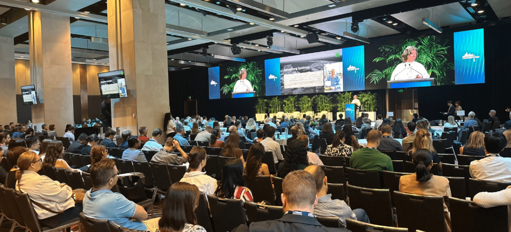People sitting at a conference listening to a speaker