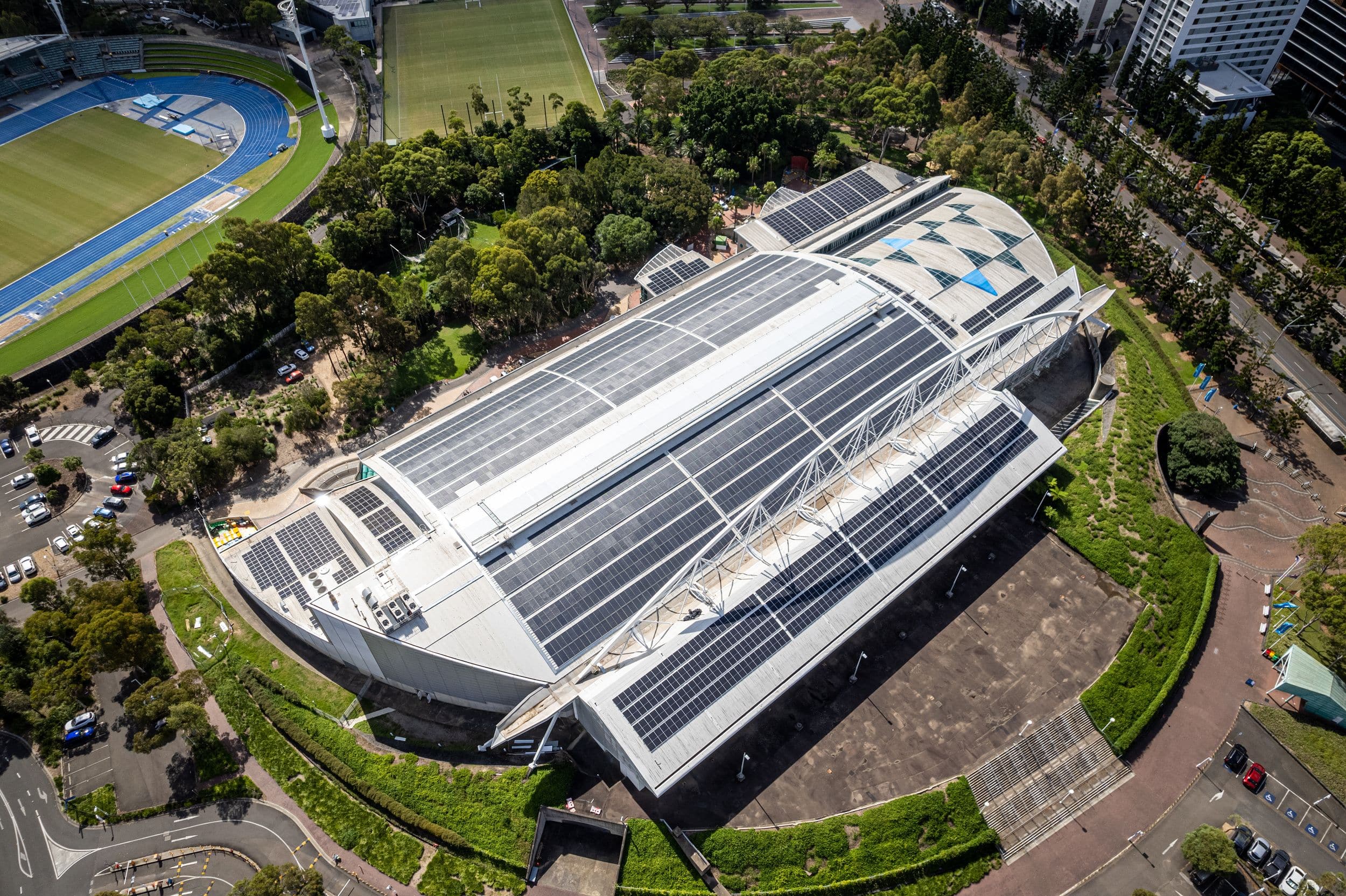 Aerial view of Sydney Olympic Park sports and events precinct featuring rooftop solar panels and sustainable building design