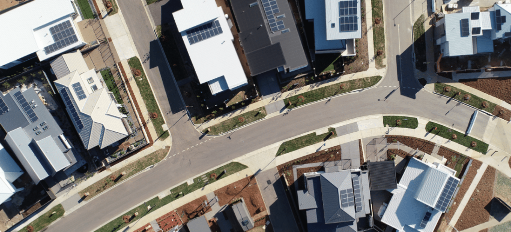 An aerial shot of a road going through a community of houses