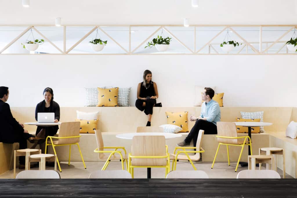 Collaborative workplace breakout space with flexible seating, biophilic design, and modern office fitout for employee wellbeing and teamwork