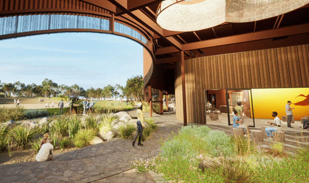 People gathered outside a timber building overlooking landscaped grounds