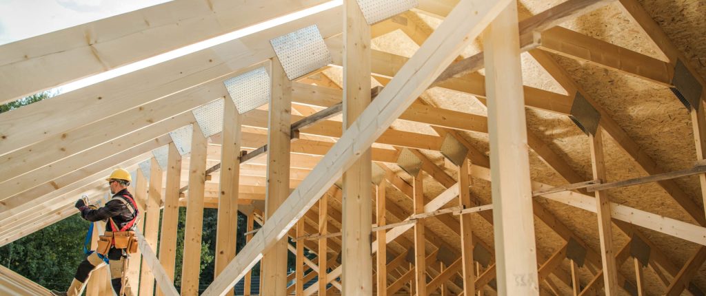 Construction Contractor Worker Building Wooden Roof Skeleton Frame of the Building. Industrial Theme.