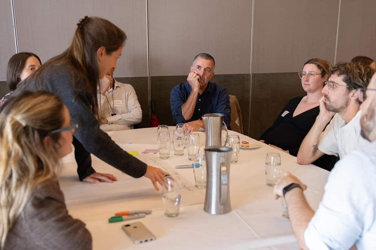 Workshop breakout session — delegates collaborating around a table at Green Building Forum 2025