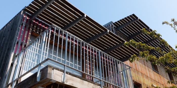 A close up image of a balcony from below with a timber roof above it